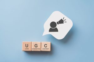 For User Generated Content Concept.(ugc) Online Marketing. Customer Create Content On Social Media . Wooden Cube Blocks With Ugc Text And Abbreviation , White Speech Bubble Paper With Icon
